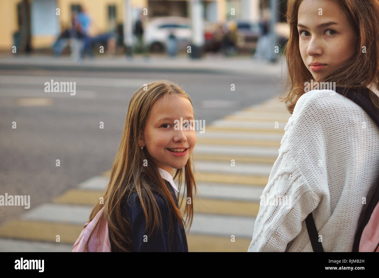 Two girls crossing the street hi-res stock photography and images - Alamy