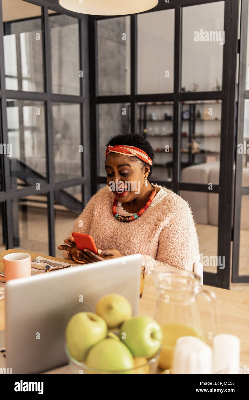 Positive woman eating breakfast texting hi-res stock photography and ...