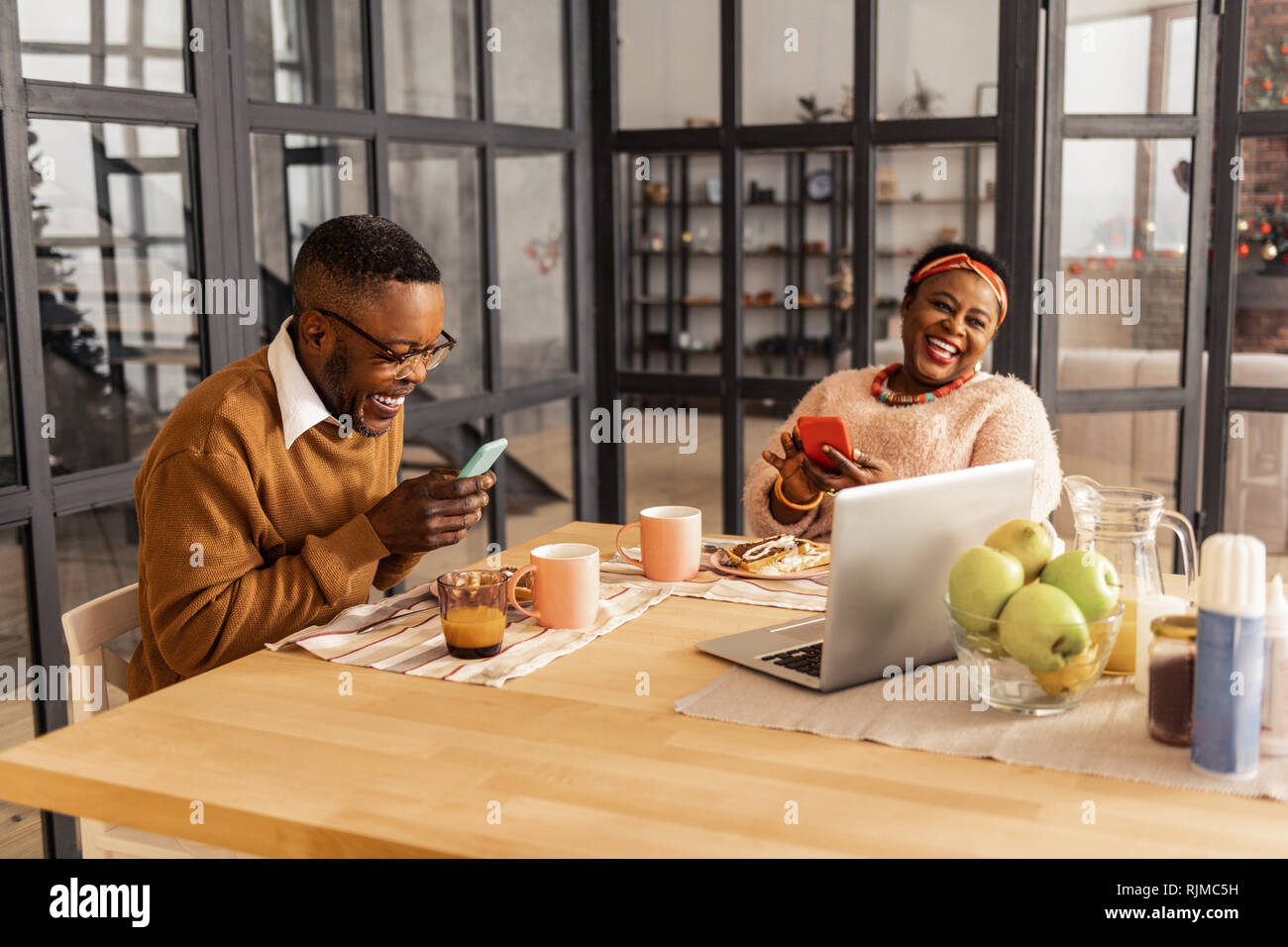 Joyful afro American couple using modern technologies Stock Photo
