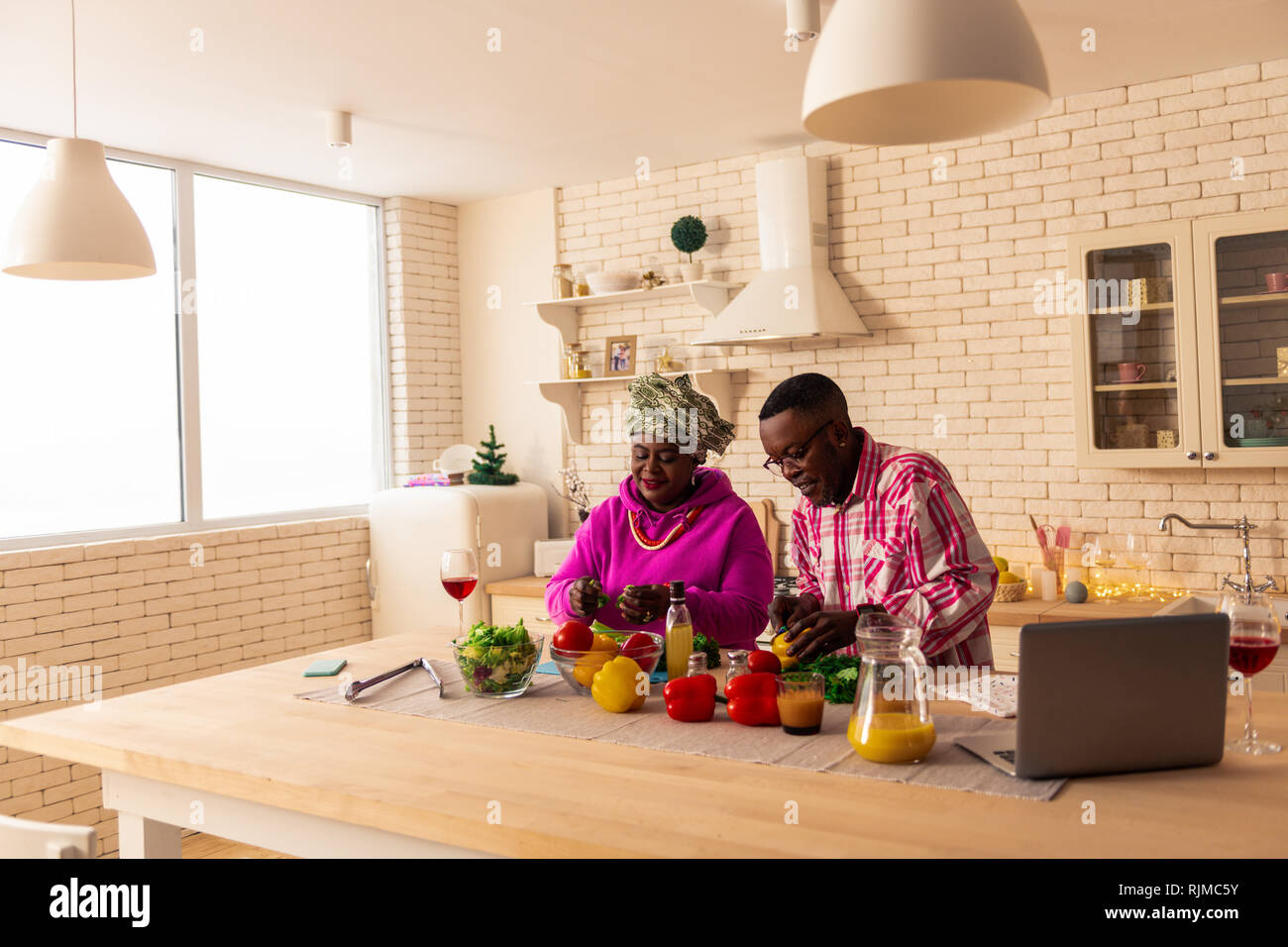 Cheerful nice African couple talking about food Stock Photo