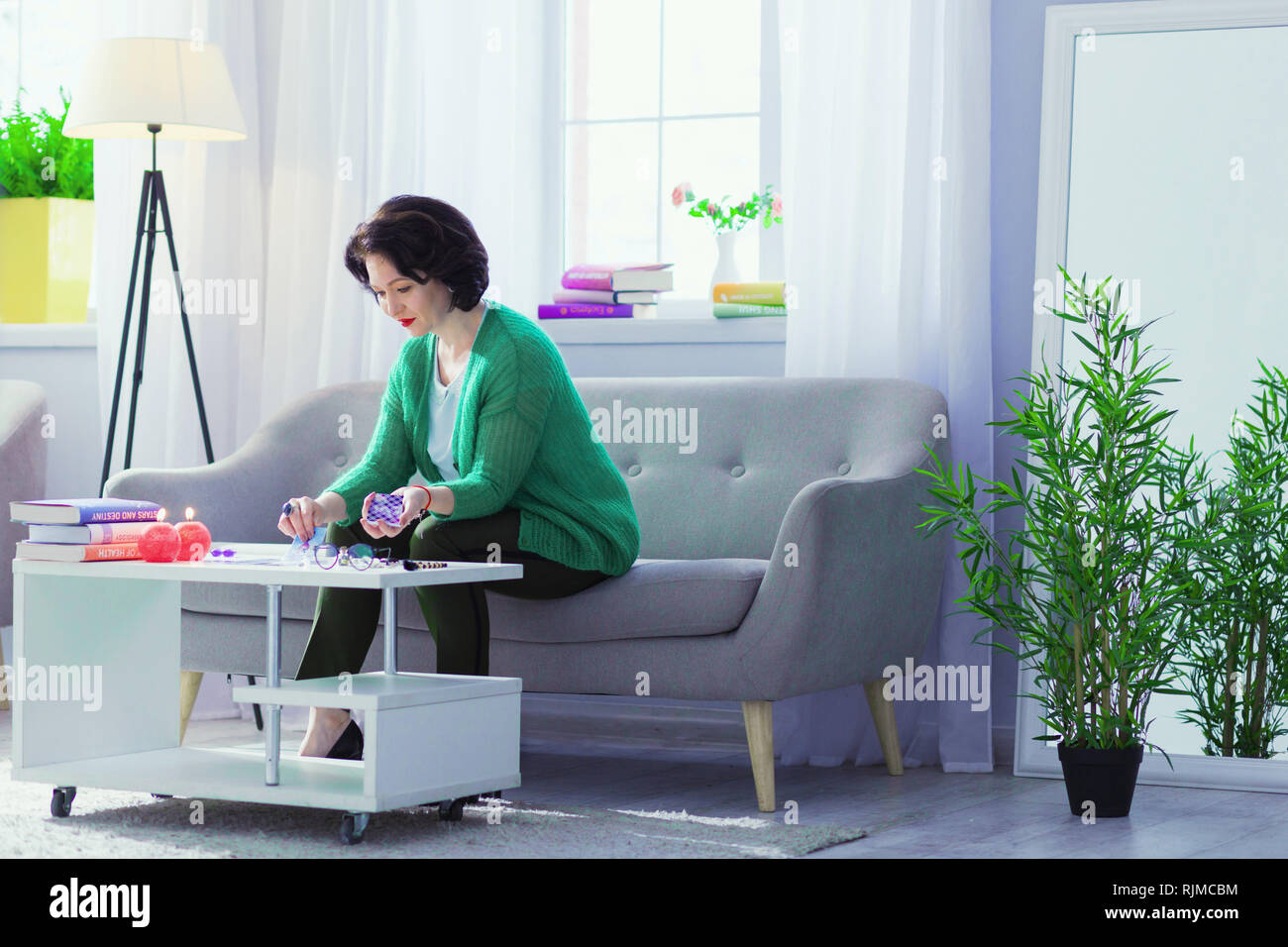 Nice good looking woman practicing magic at home Stock Photo
