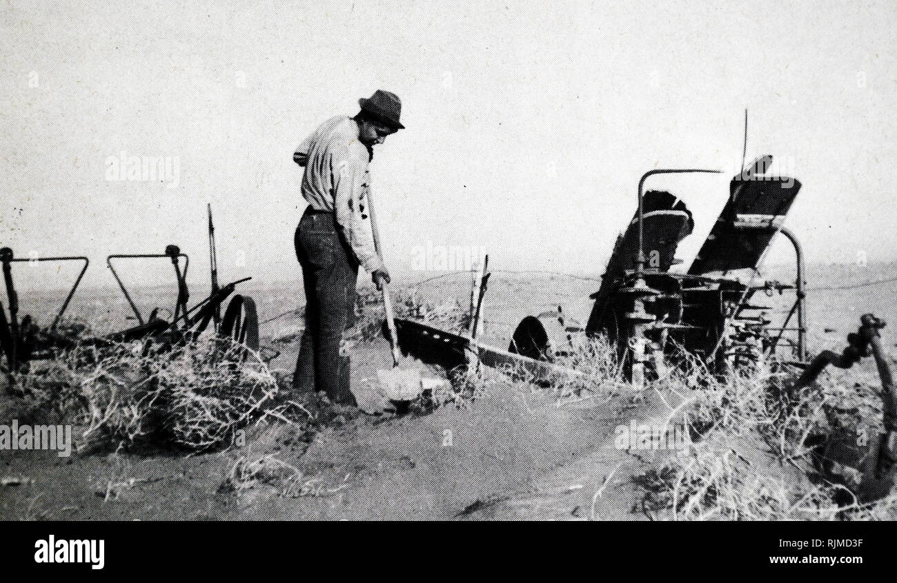 Farmer working during the Black Blizzard Dust Storm during the severe drought across the dust bowl in America 1934 Stock Photo