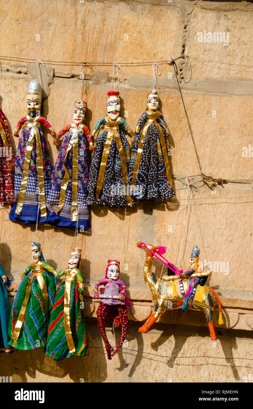 Colorful Kathputli or Puppets displayed on the wall, near Patwon Ki Haveli, Jaisalmer, Rajasthan, India Stock Photo