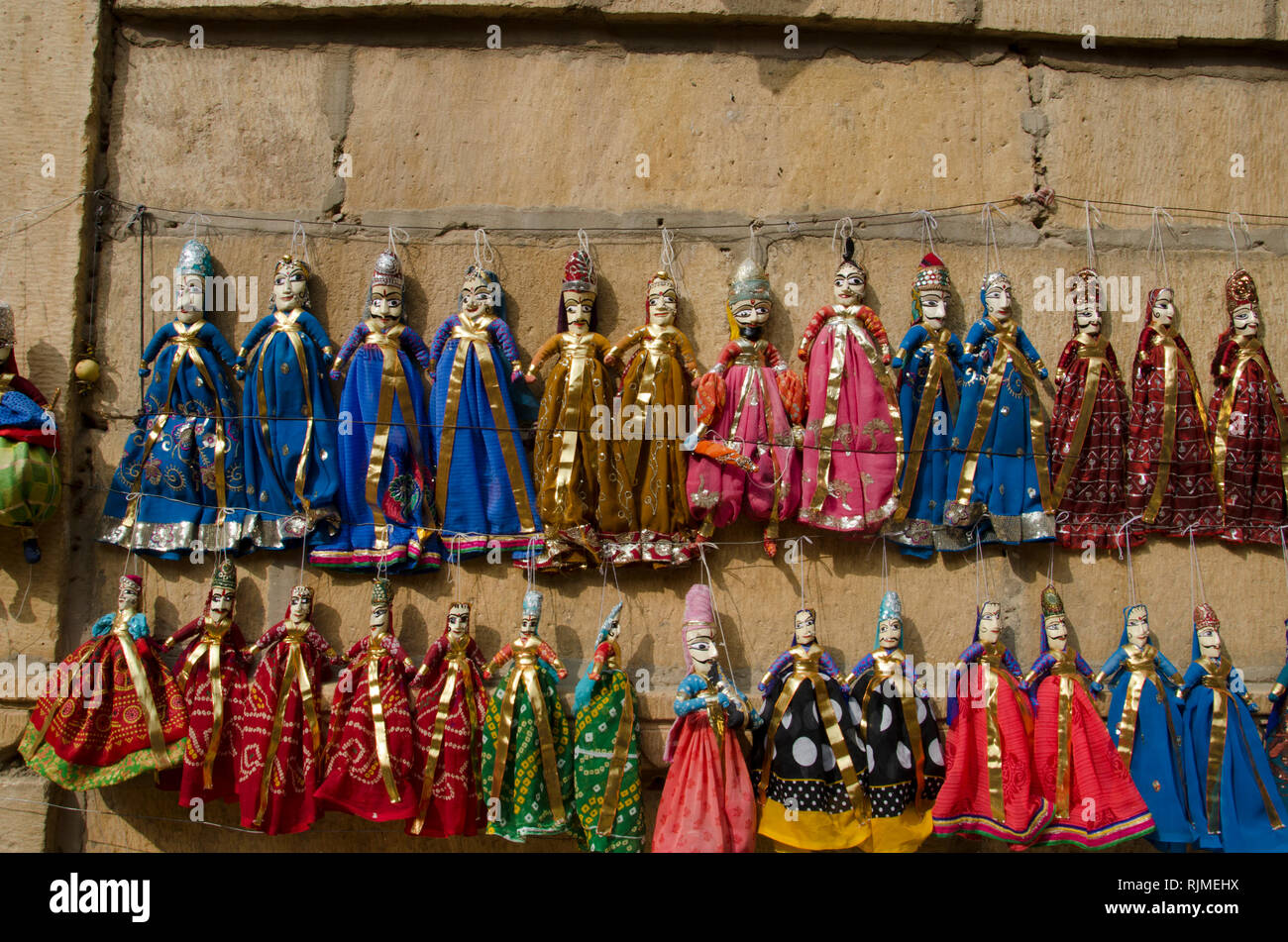Colorful Kathputli or Puppets displayed on the wall, near Patwon Ki Haveli, Jaisalmer, Rajasthan, India Stock Photo