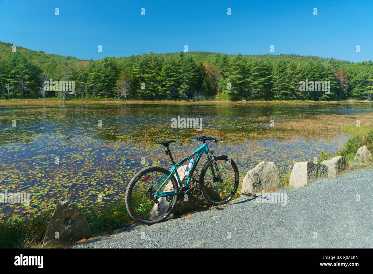 Mountain bike parked on a carriage road  edging Eagle Lake in Acadia National Park, Maine, USA. Stock Photo