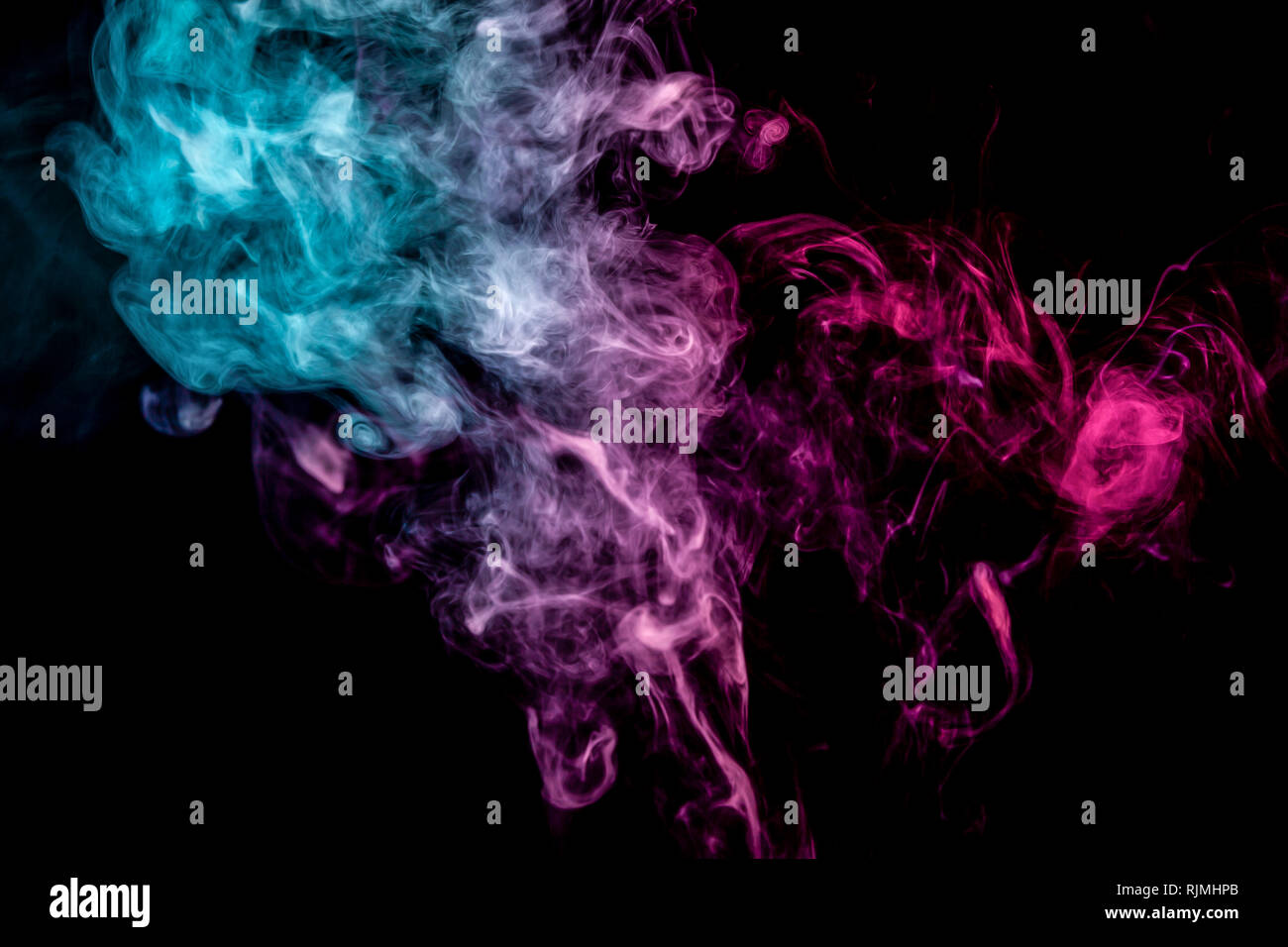 Blue and pink bomb smoke on black isolated background Stock Photo - Alamy