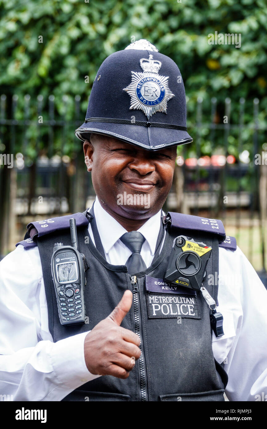 United Kingdom Great Britain England London Parliament Westminster Palace Metropolitan Police security guard constable uniform body cam walk Stock Photo