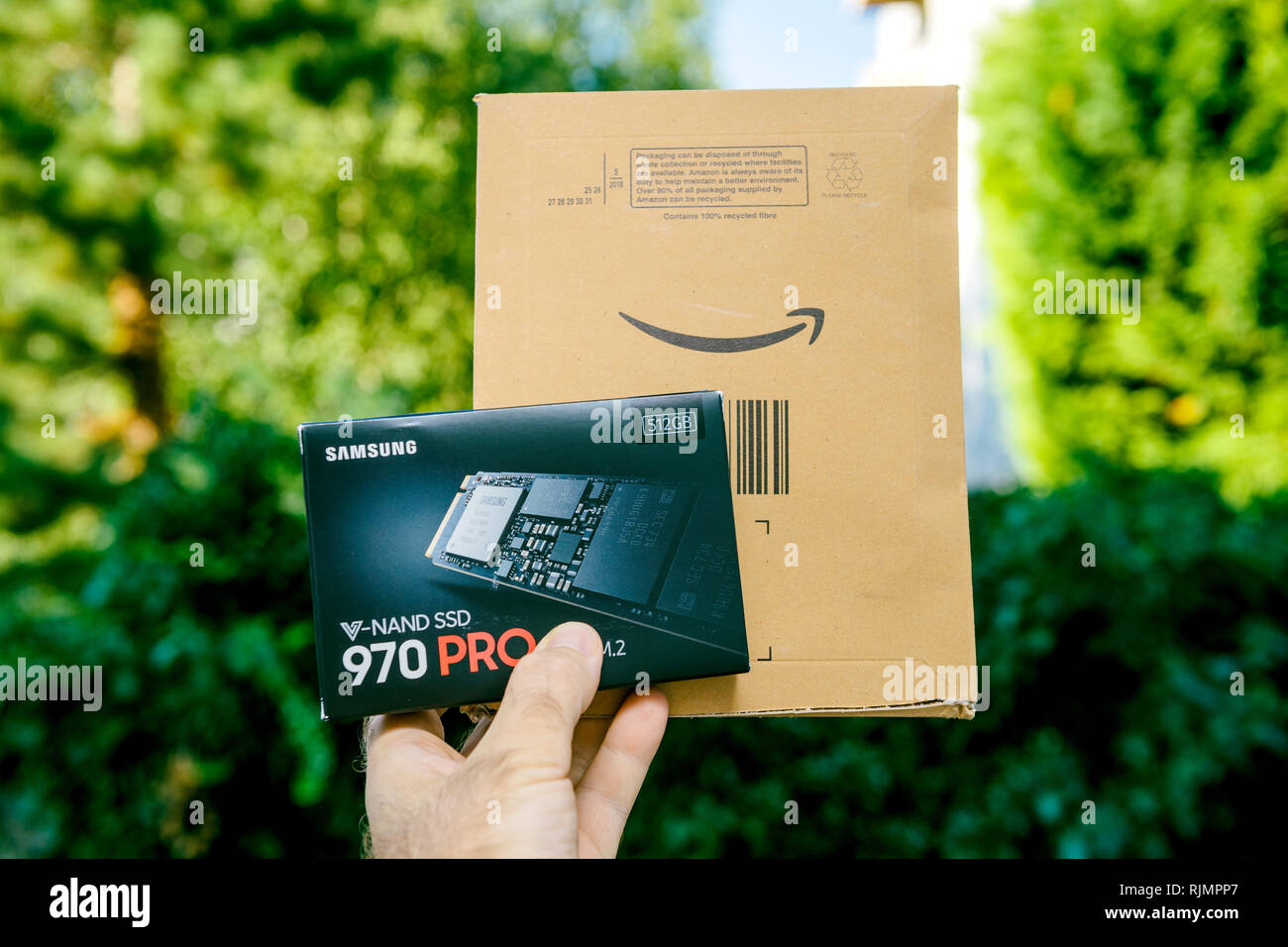 PARIS, FRANCE - AUG 3, 2018: Man hand holding packaging box of NVME PCIE SSD  hard drive disk with high read and write speed Samsung 870 Pro unboxing  from Amazon Prime cardboard Stock Photo - Alamy