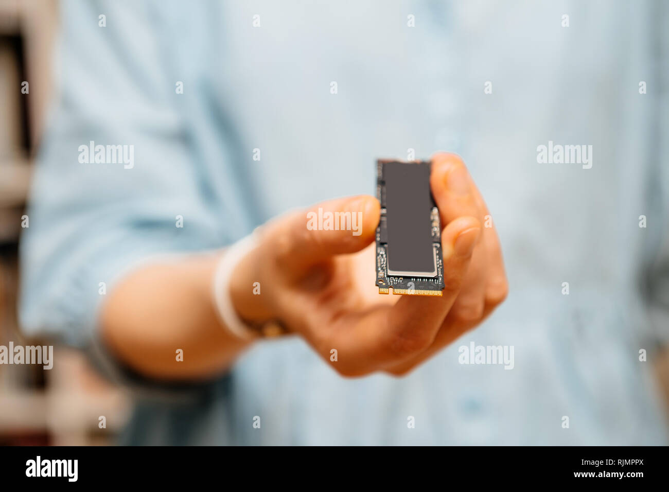 Horizontal photo of woman holding demonstrating new NVME PCIE SSD hard