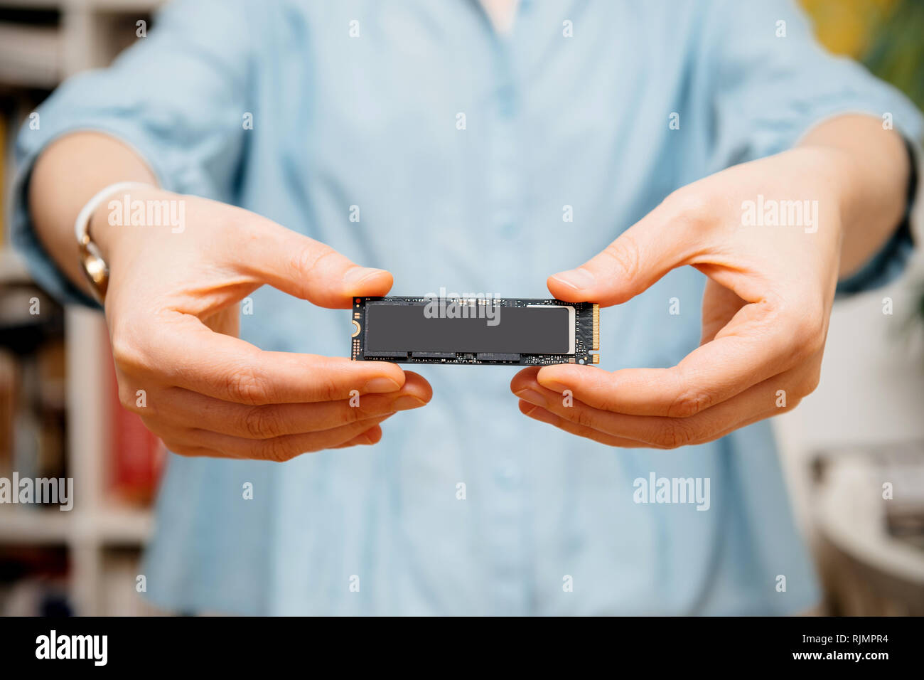 Woman holding with two hands new NVME PCIE SSD hard drive disk with ...