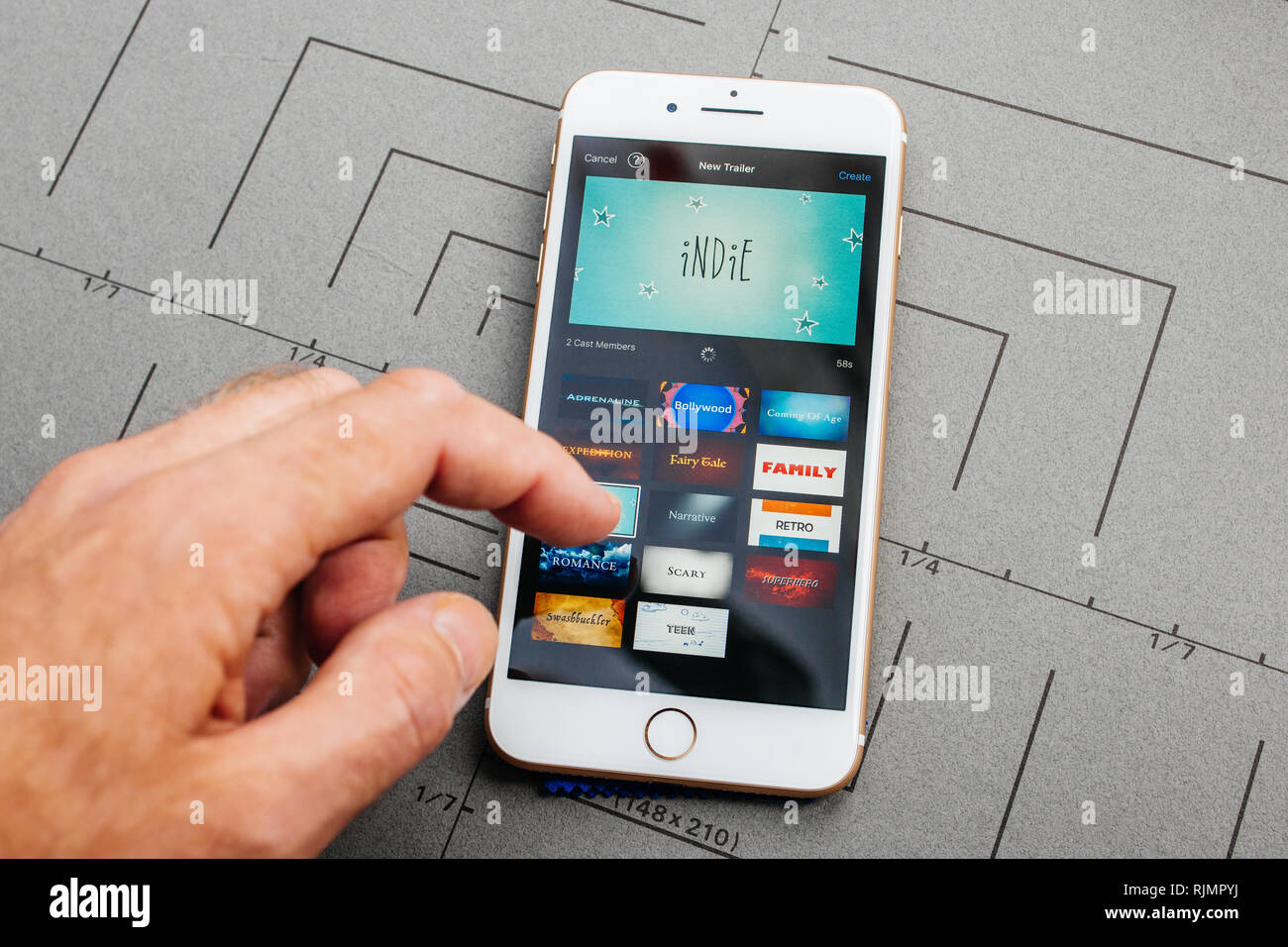 PARIS, FRANCE - SEP 26, 2016: Male hand holding New Apple iPhone 7 8 Plus  after unboxing and testing by installing the app application software  iMovie trailer new Stock Photo - Alamy