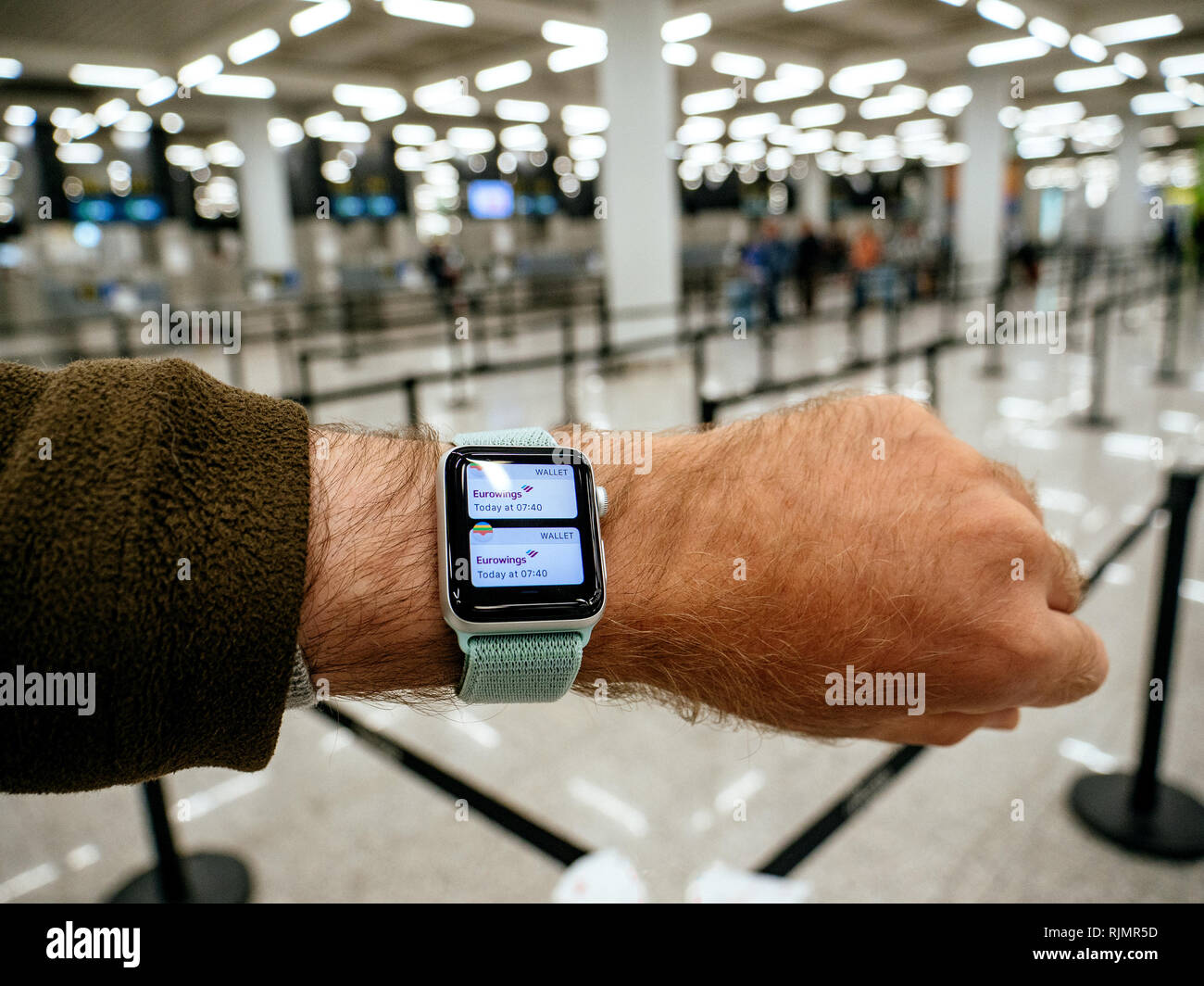 BARCELONA, SPAIN MAY 11, 2018: Crop male hand with Apple Watch Series 3  smartwatch using device while standing in light modern airport Wallet App  with Eurowings ticket Stock Photo - Alamy