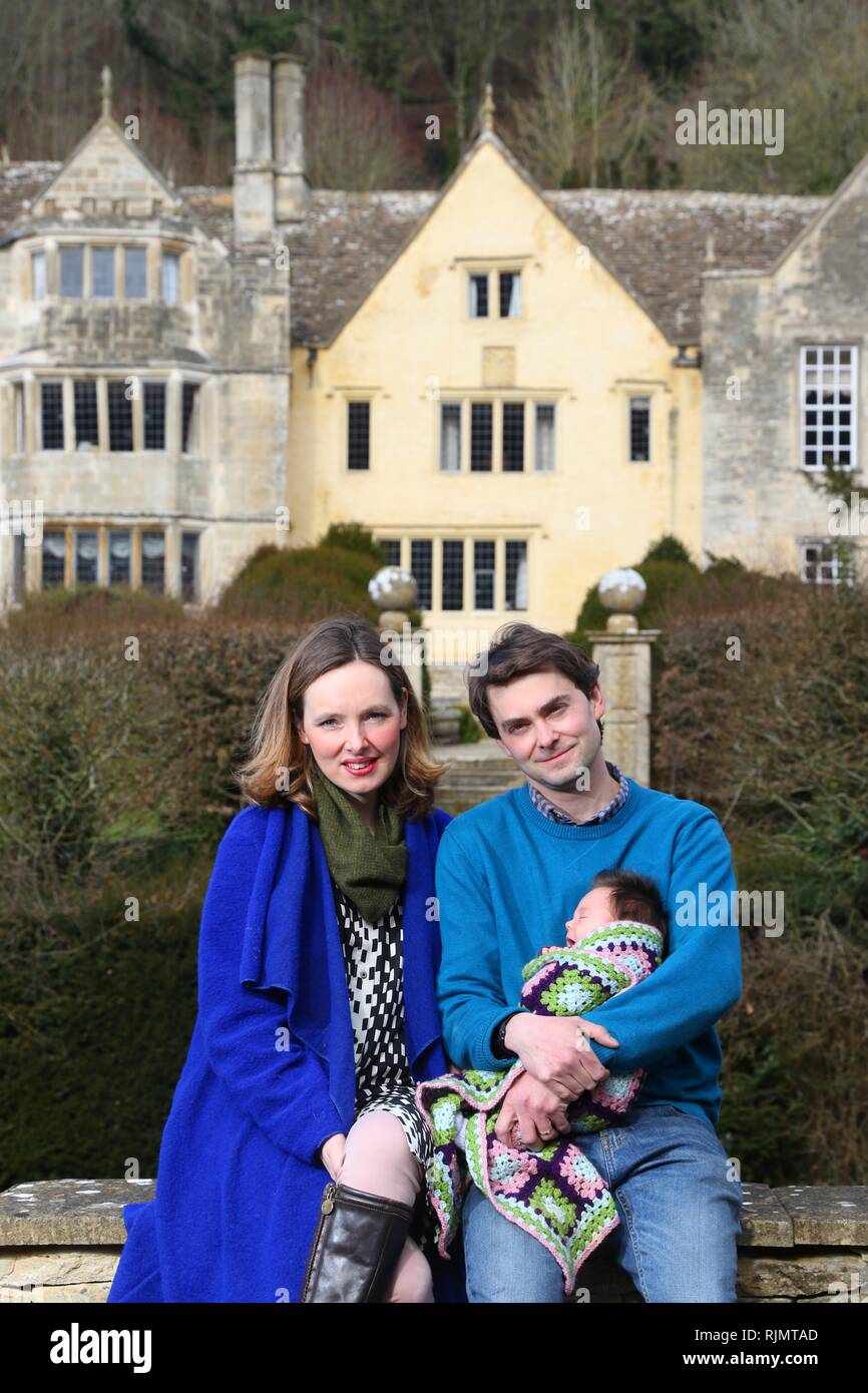Ciara and Hugo Mander with baby Luna, at Owlpen Manor, their grade 1 listed Tudor country house in the village of Owlpen, near Stroud, Gloucestershire Stock Photo