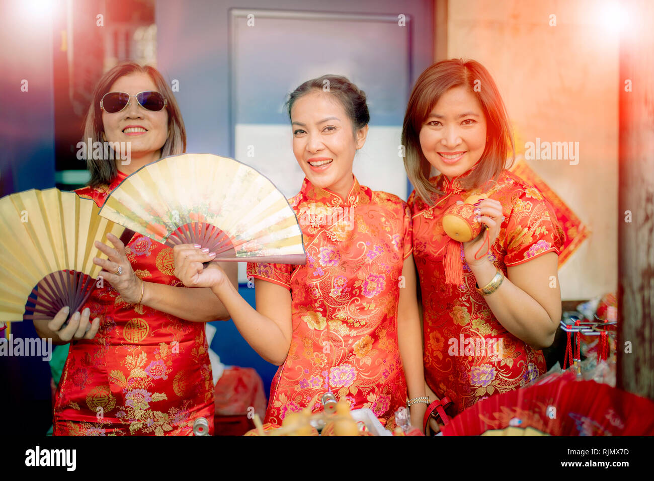 group of asian woman wearing chinese tradition clothes toothy smiling face happiness emotion and hand sign i love you Stock Photo