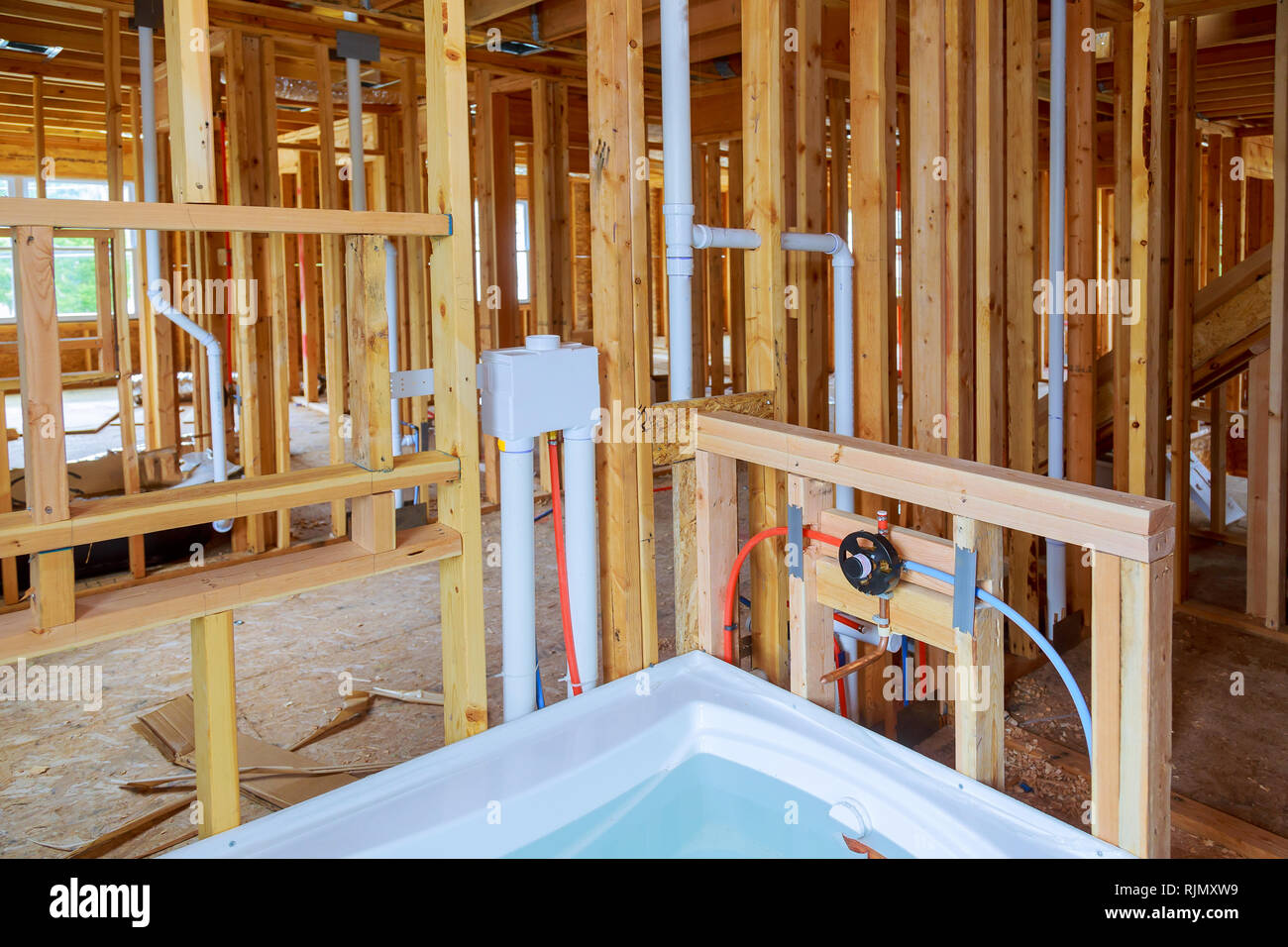 Interior wall framing with piping and bathroom installed Plumbing pipes