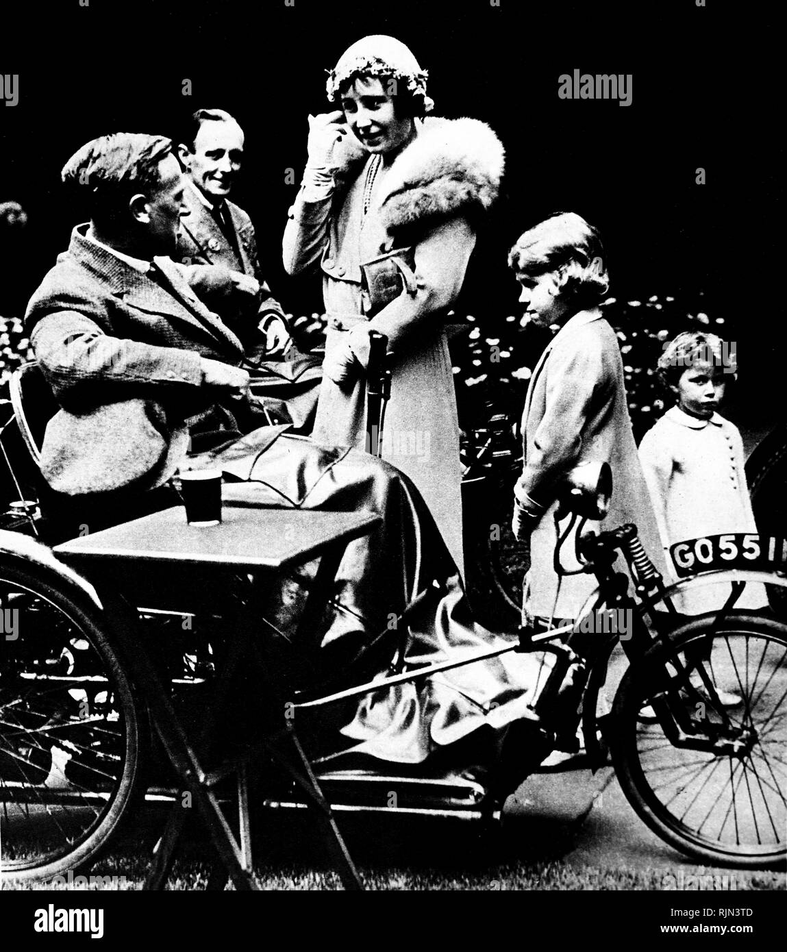 The Duchess of York meets a disabled ex-soldier. She is joined by the future Queen Elizabeth II and Princes Margaret. 1933 Stock Photo