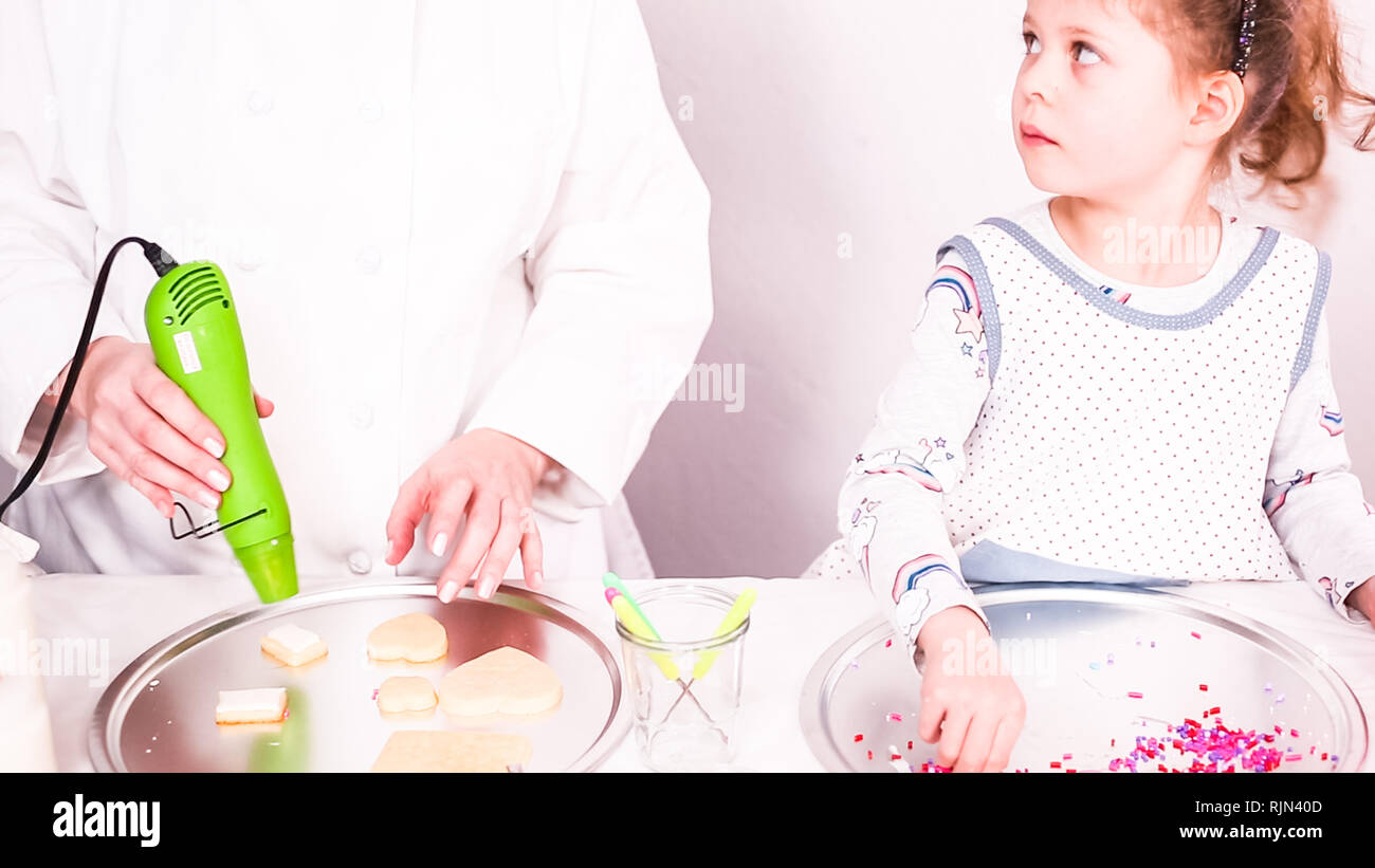 Step by step. Drying royal icing on sugar cookies with small heat gun