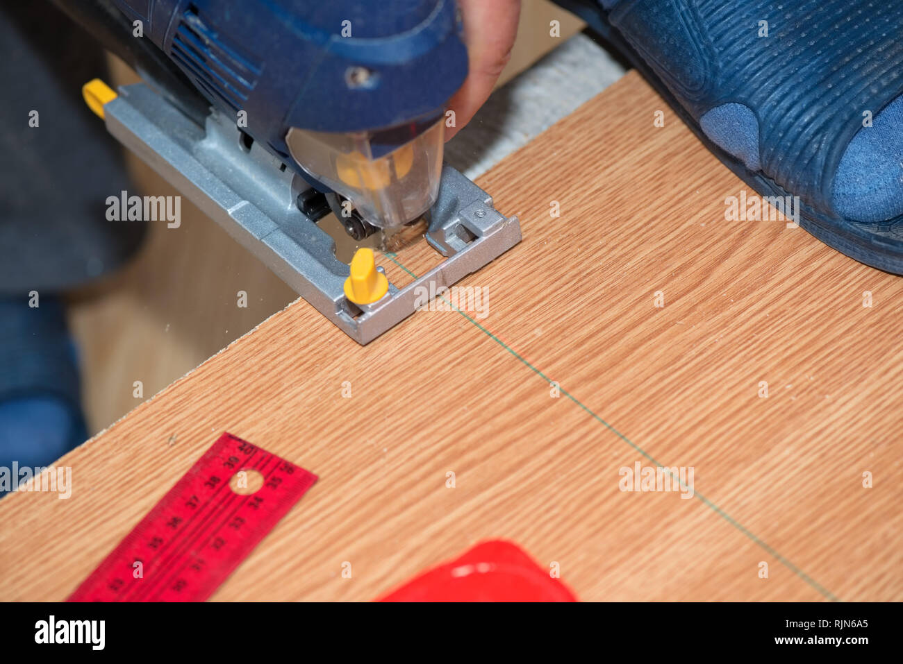 Electrical machine cutting a wooden plank Stock Photo