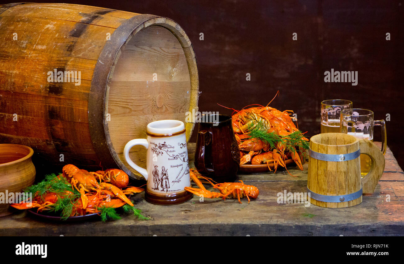 Beer with crayfish near the wooden barrel. Oktoberfest. Stock Photo