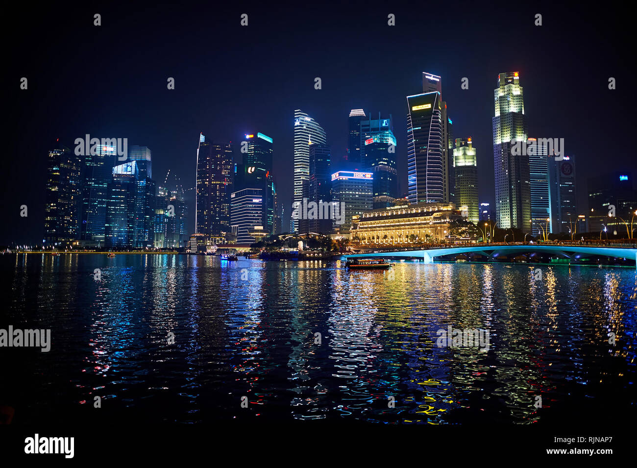 SINGAPORE - NOVEMBER 08, 2015: Singapore downtown at night. Singapore, officially the Republic of Singapore, and often referred to as the Lion City, t Stock Photo