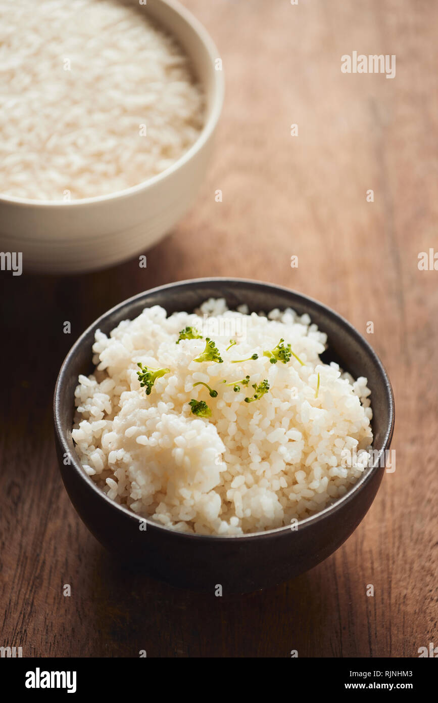 cooked jasmine rice and raw organic rice Stock Photo