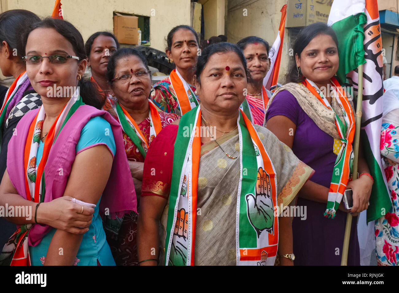 Female Congress Party supporters in Mumbai, India, with flags and shawls of the party's symbols Stock Photo