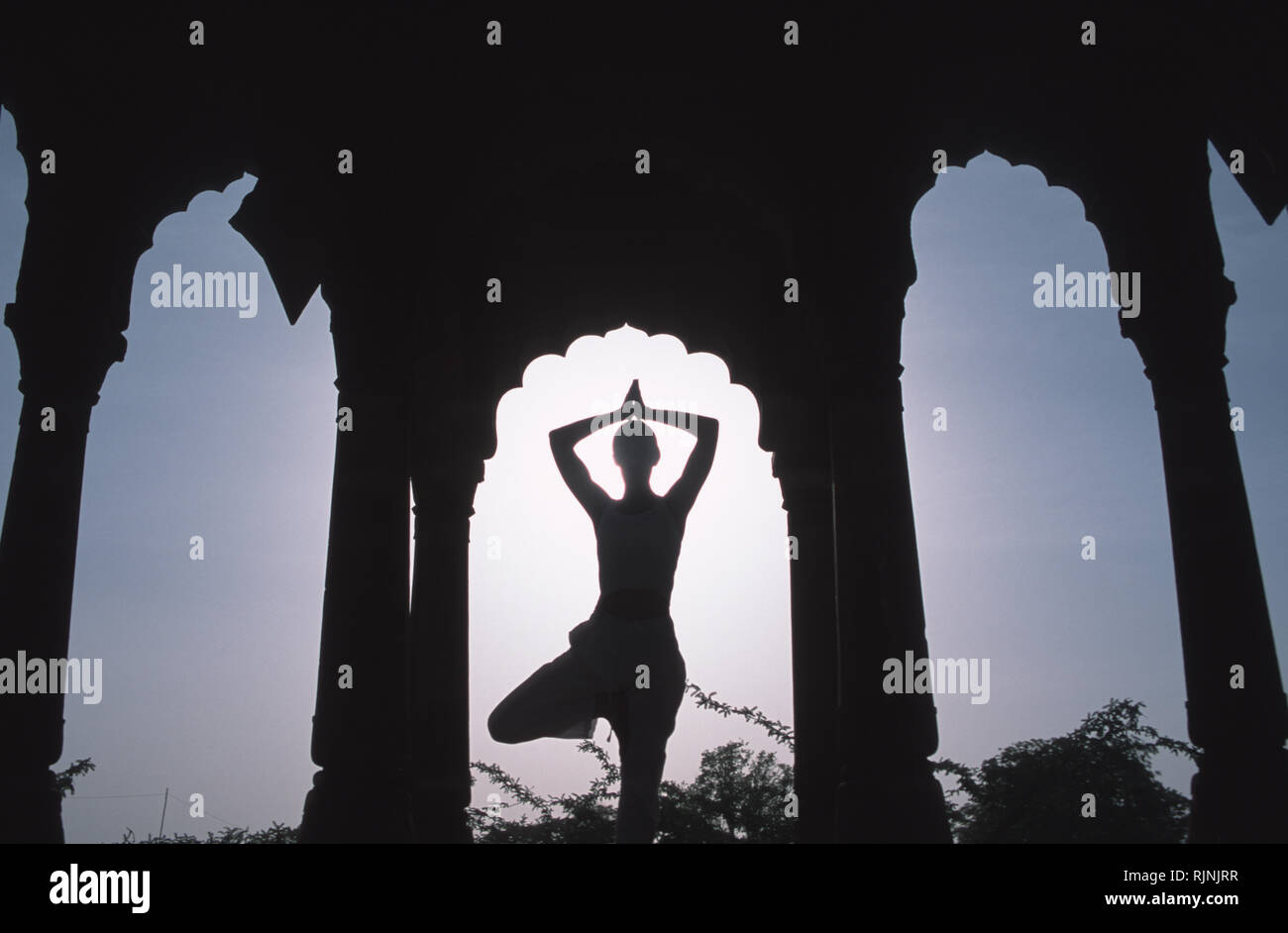 Caption: Khimsar, Rajasthan, India - Apr 2003. An asana yoga pose within the ruins of a Rajasthani palace at Kimsar, a small village on the edge of th Stock Photo