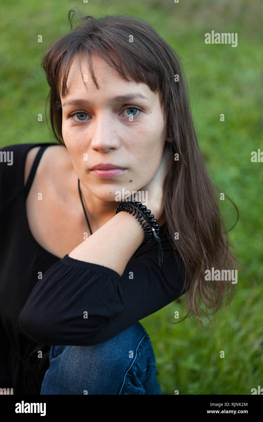 Beautiful woman with blue eyes in the park Stock Photo Alamy