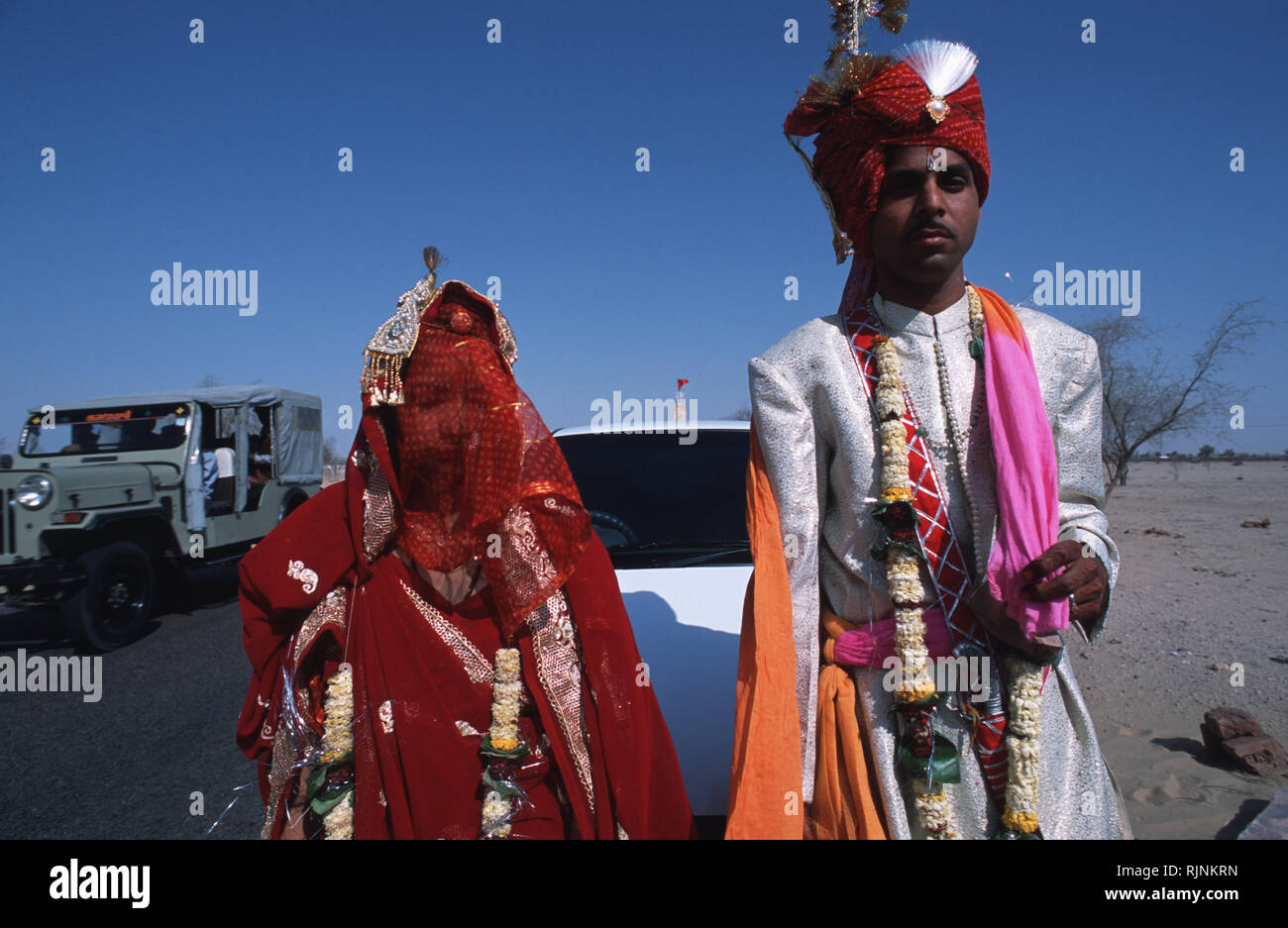 Caption: Bikaner, Rajasthan, India - Apr 2003. A rajasthani couple after their wedding ceremony conducted on the edge of a higheay near Bikaner, weste Stock Photo