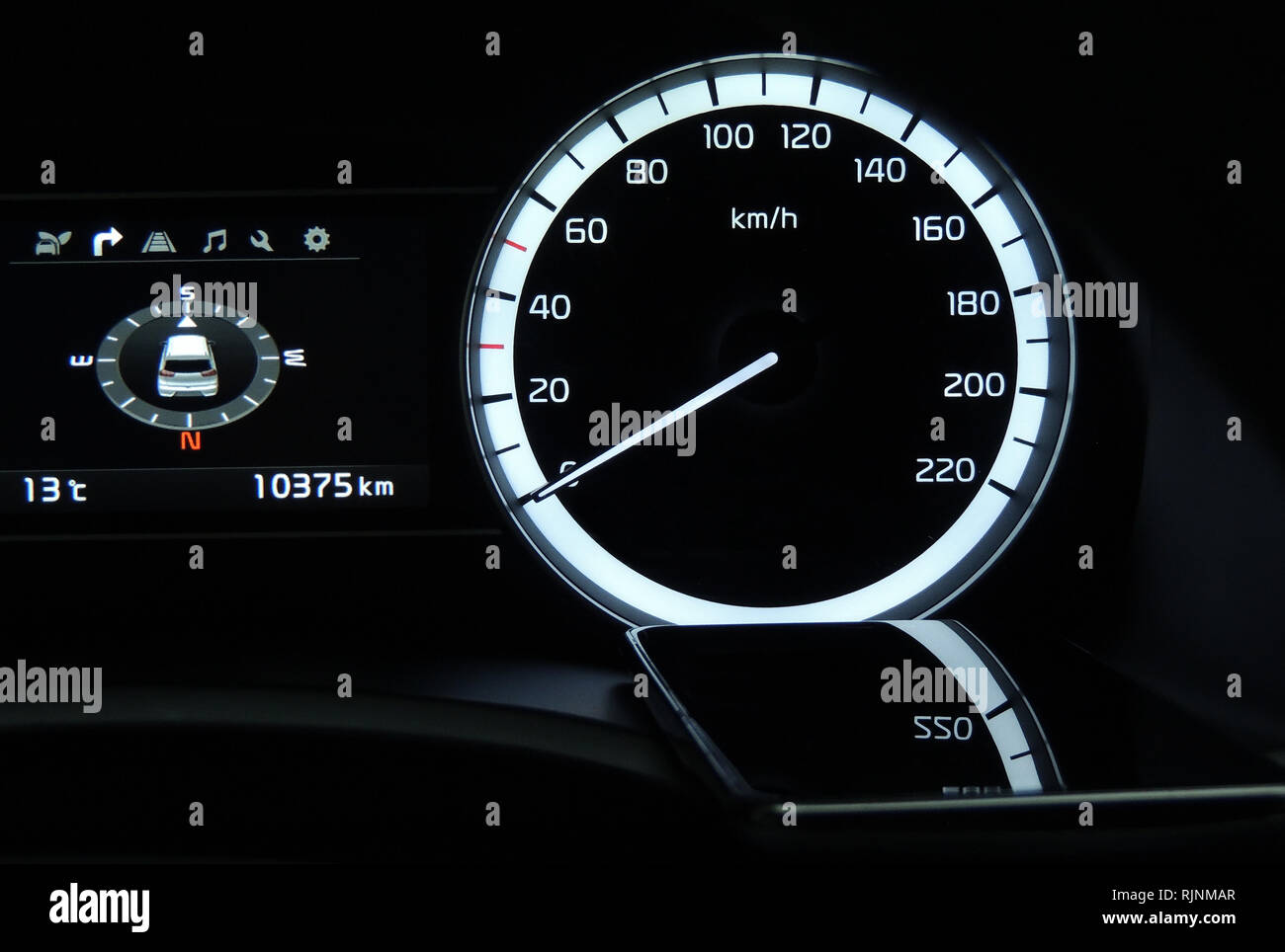 Mobile phone indicate reflection of car speedometer and digital