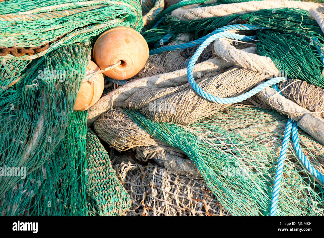 Bunch of old weathered trawl fishing net background Stock Photo