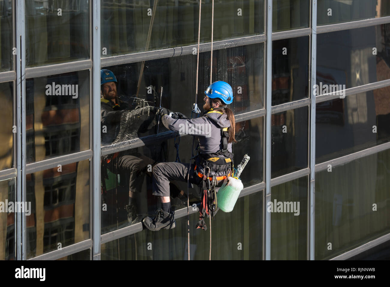 Abseiling Window Cleaners. Cleaning Windows at The Crowne Plaza in Nottingham City Centre Stock Photo