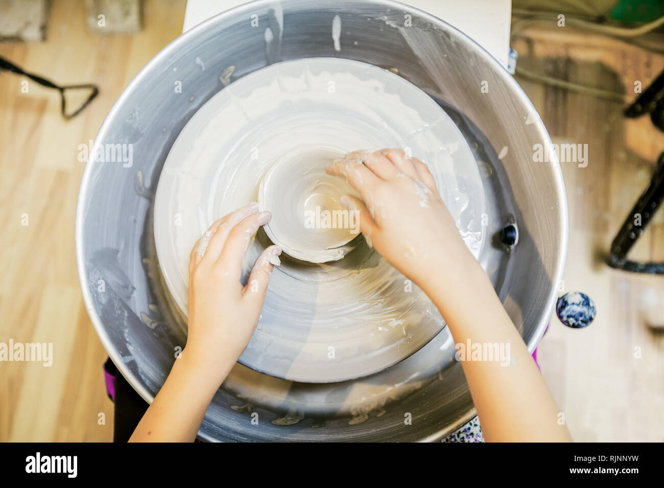 Top view of child hands working with clay on pottery wheel Stock Photo ...
