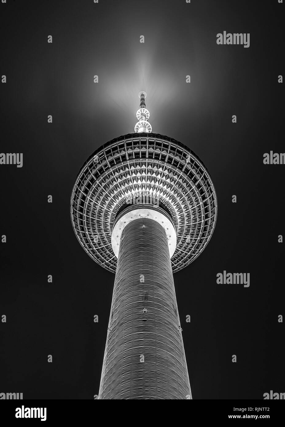 Berlin Germany. Silver sphere of Fernsehturm TV tower by night in black and white Stock Photo