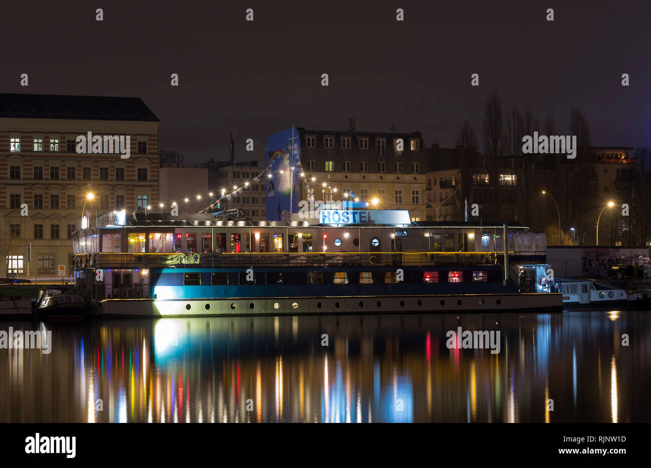 Hostel ships in River Spree Berlin by night. Near Eastside Gallery. Multiple colored lights Stock Photo