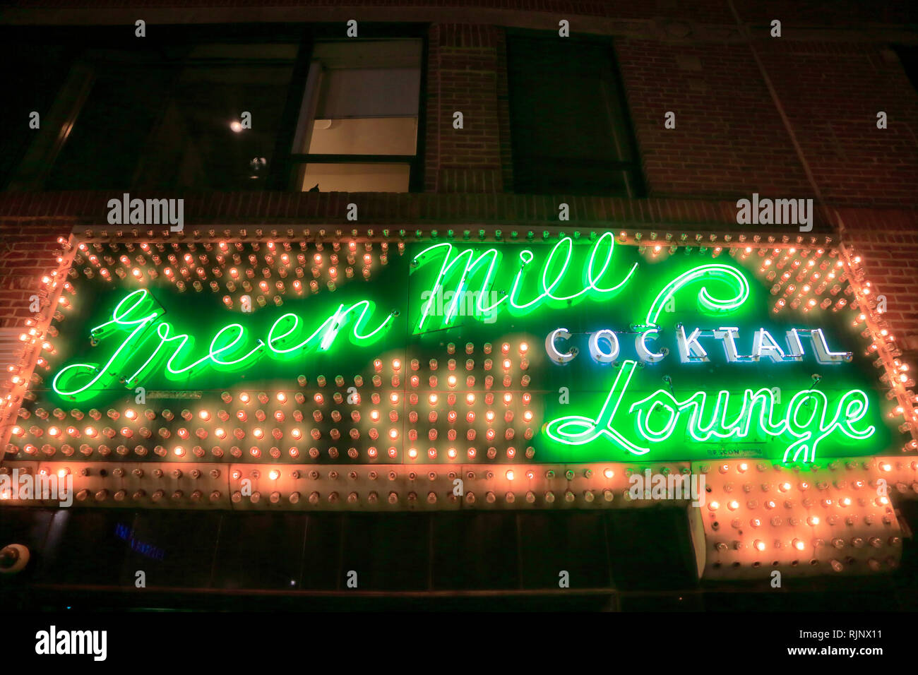 Night view of the neon and light sign above the entrance of Green Mill ...