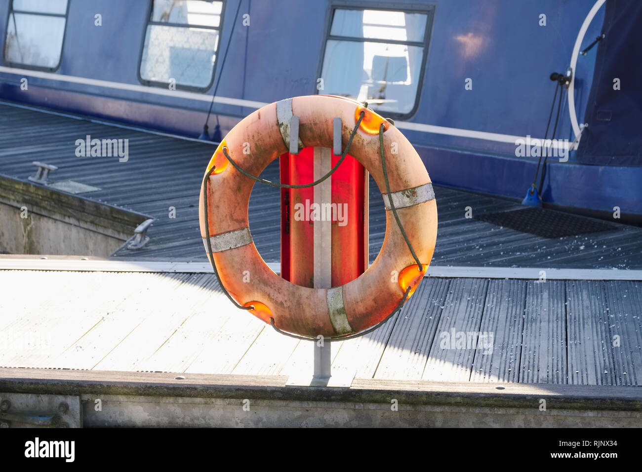 Life buoy orange ring water safety at boat mooring marina Stock Photo