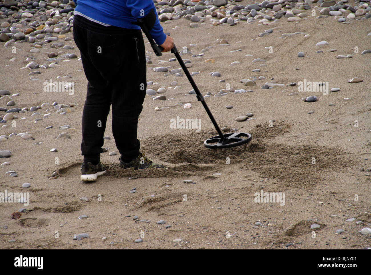 Man looking for valuable items with a metal detector at the beach Stock ...