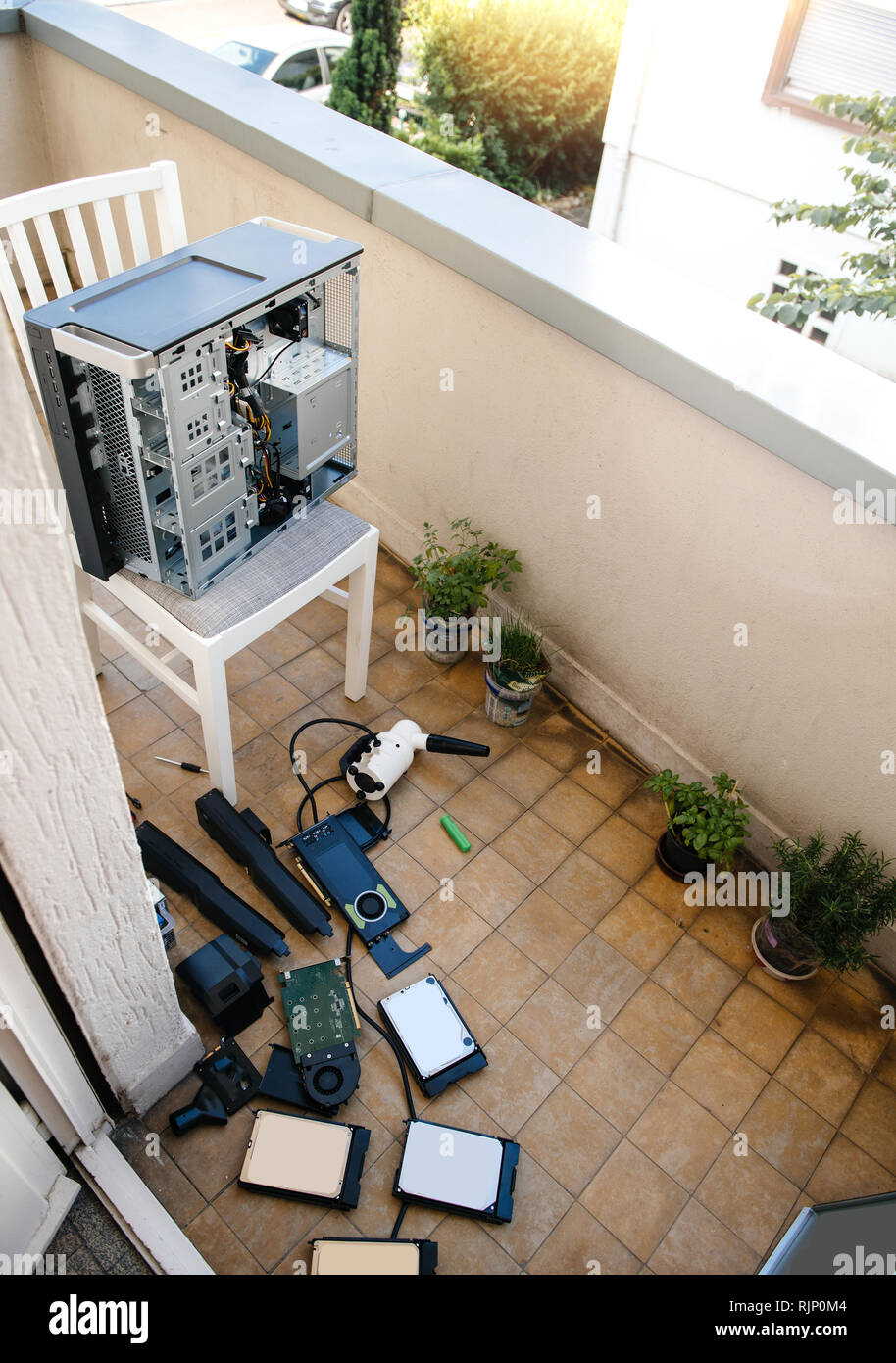 Home balcony with vacuum pump to clean computer workstation case on