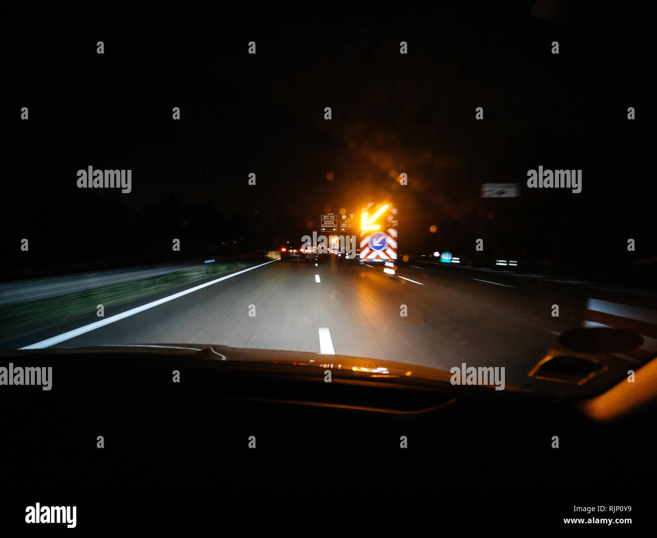 Shot from inside of car driving down road in night time with blurry ...