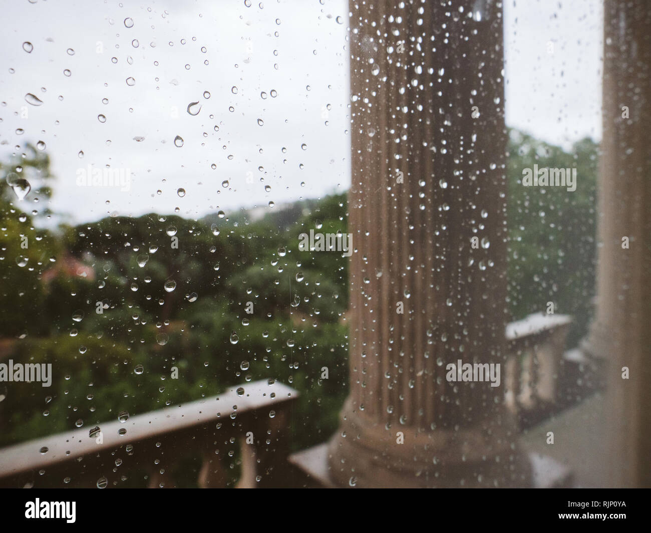 Rainy weather in luxury castle palace - shot through glass in raindrops ...