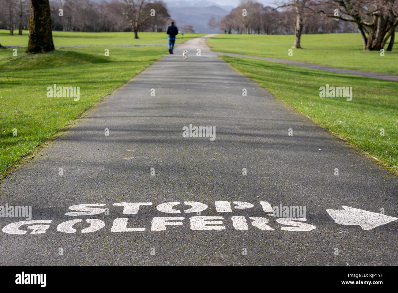 Caution warning as Stop golfers warning text sign written on alley in Killarney golf and fishing club Fossa, Killarney National Park, Kerry, Ireland Stock Photo