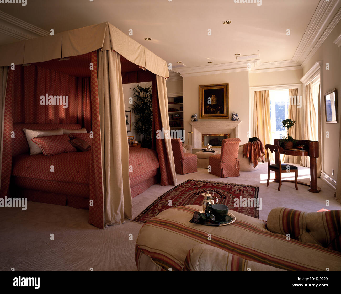 Cream Drapes On Bed In Opulent Bedroom Stock Photo