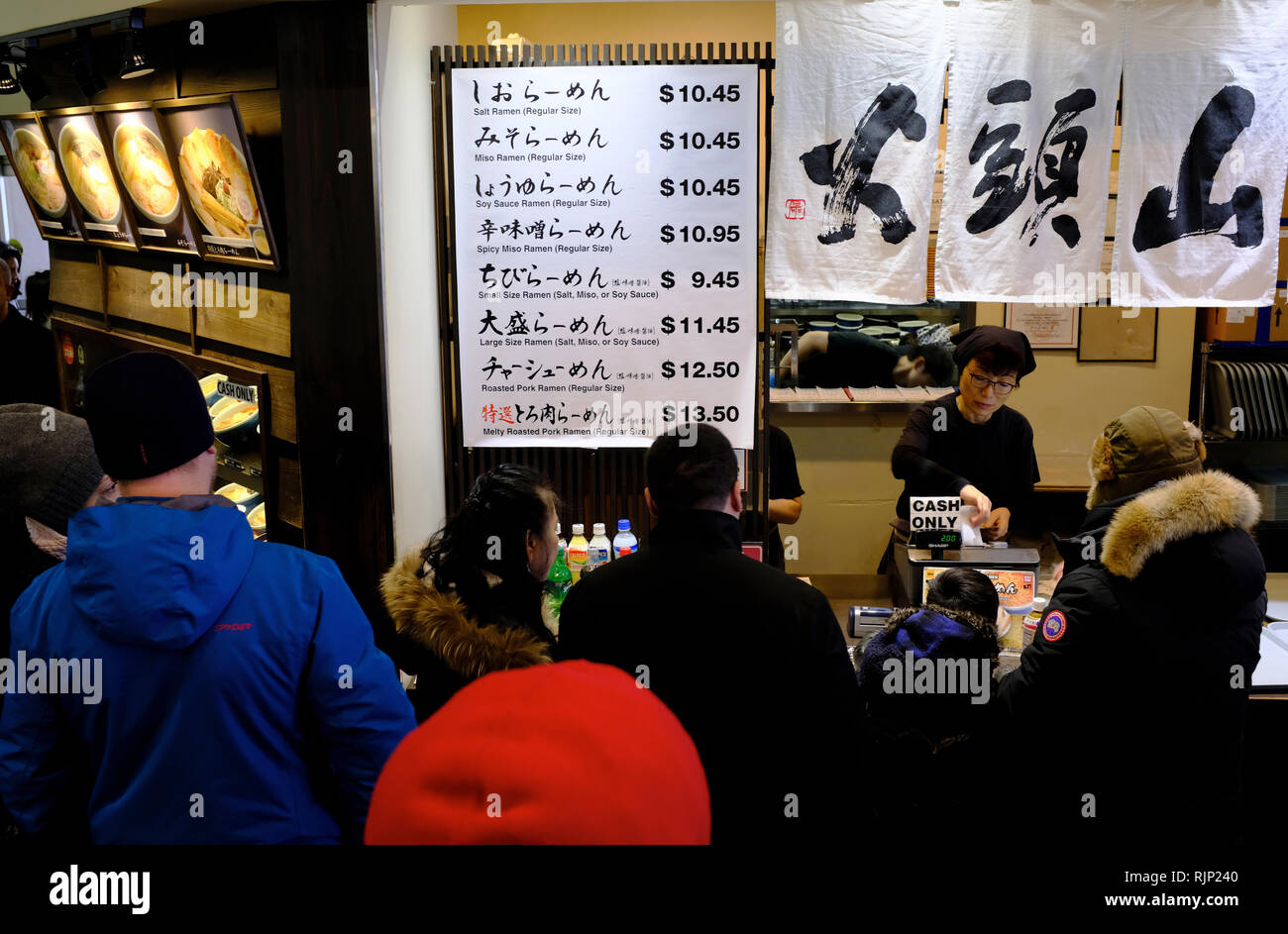 Customers waiting in line by the counter of a Japanese take out restaurant in Mitsuwa Marketplace,Fort Lee. New Jersey. USA Stock Photo