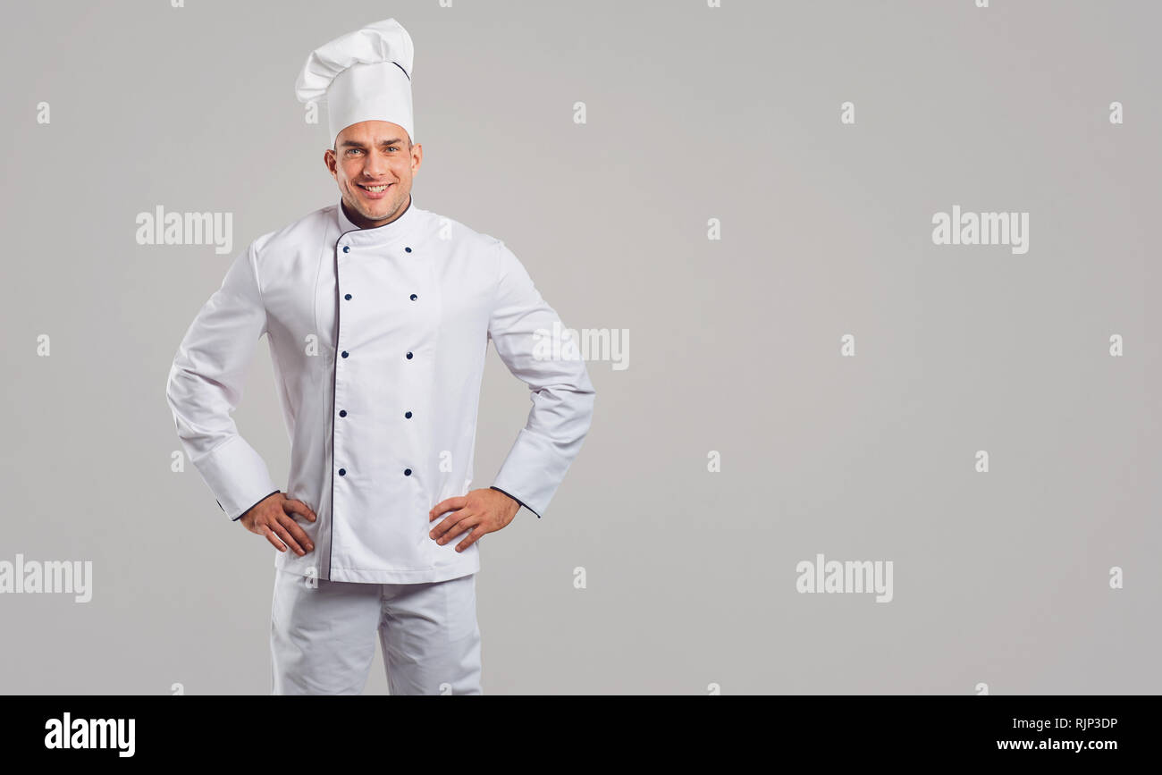 Chef in white uniform is smiling. Stock Photo