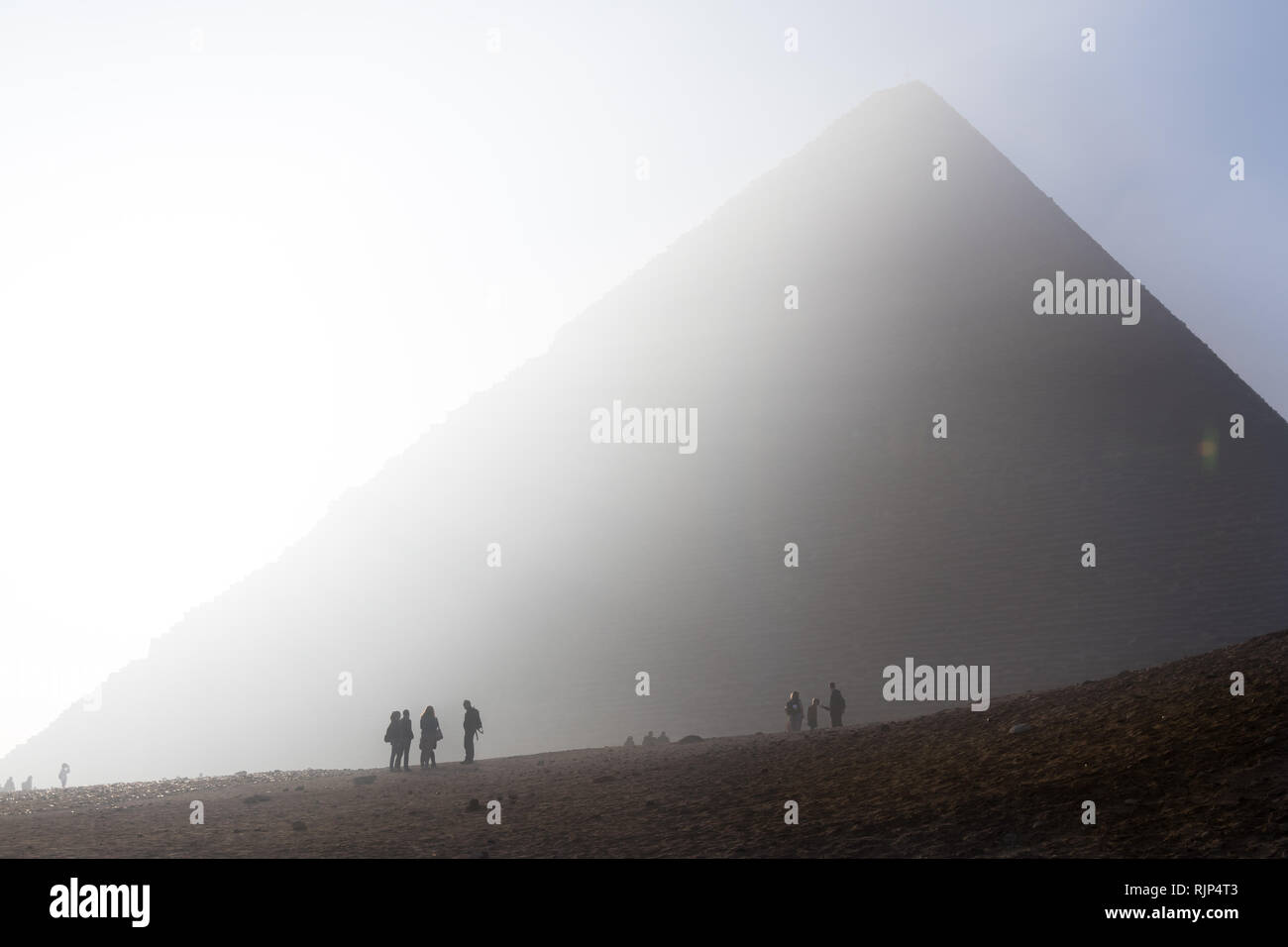 Sunrise and early visitors in front of the Great Pyramid of Giza (Pyramid of Khufu) at Giza near Cairo, Egypt. Stock Photo
