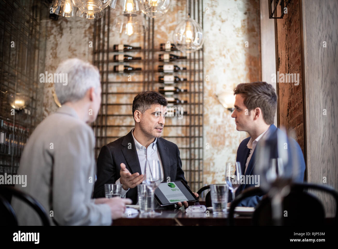 Business executives having a working lunch in a restaurant Stock Photo