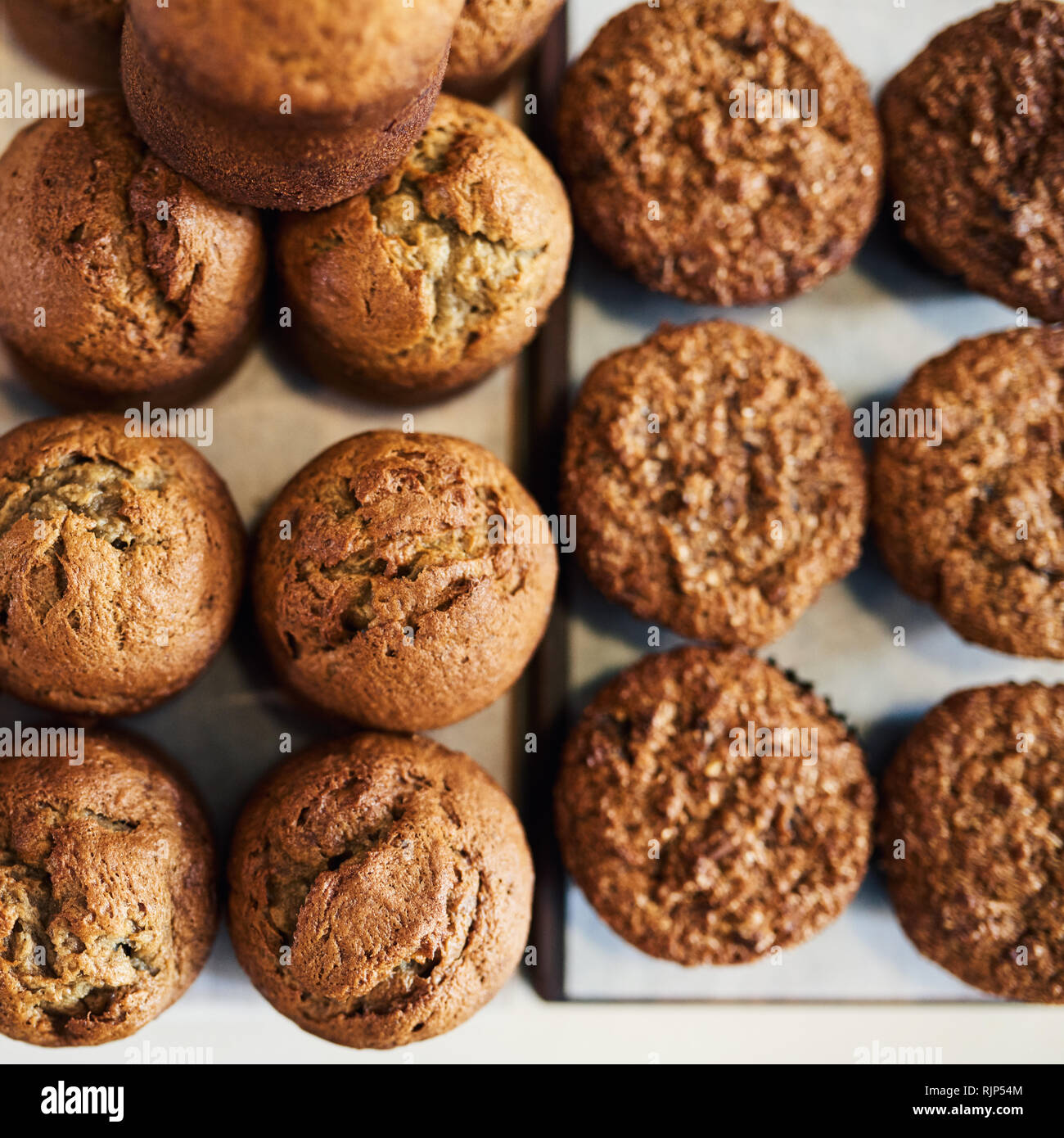 Delicious assortment of muffins sitting on cafe serving boards Stock Photo