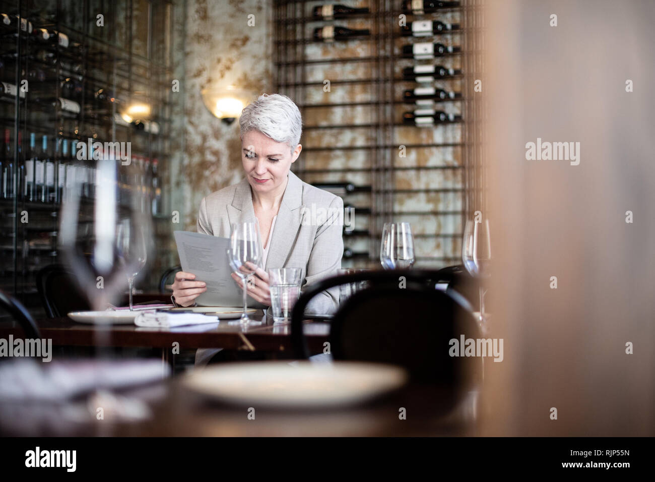 Businesswoman reading menu in a restaurant Stock Photo