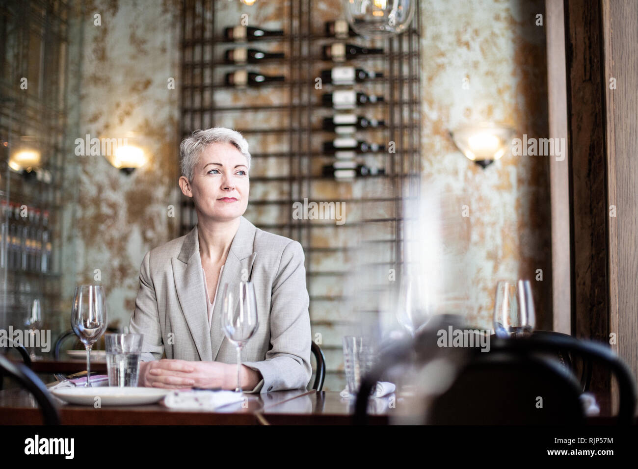 Successful businesswoman thinking in a restaurant Stock Photo